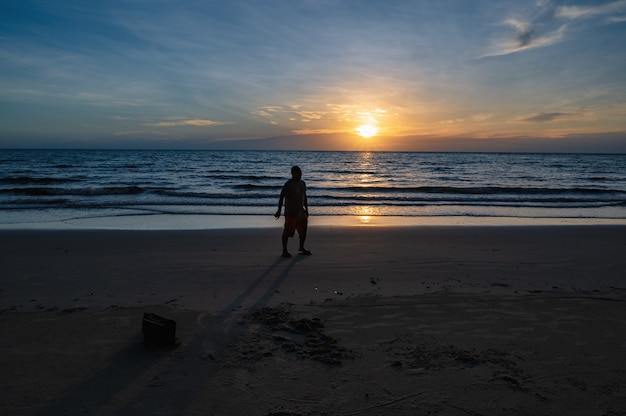 Silhouette people with Beautiful idyllic seascape sunset view on kohkood island in low season travel.Koh Kood, also known as Ko Kut, is an island in the Gulf of Thailand