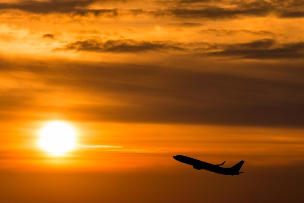 Silhouette person against orange sky during sunset