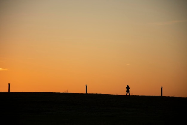 Silhouette of person on hike at sunrise