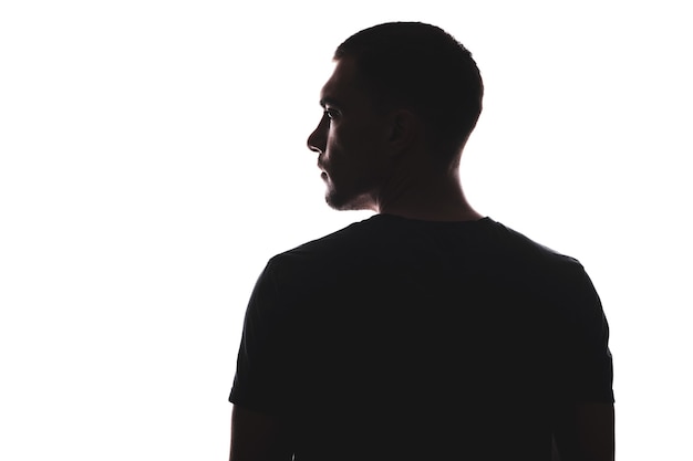 Photo silhouette portrait of man with his back looking away, isolated