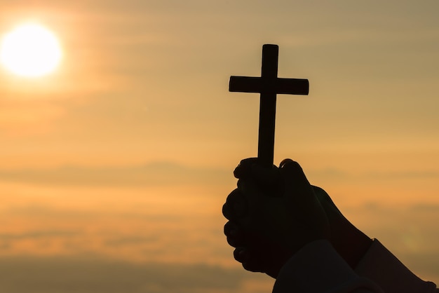 Photo silhouette of prayer woman worship god in the morning with sunrise sky background christian religion concept person hands open palm up worship god helping repent catholic easter lent mind pray