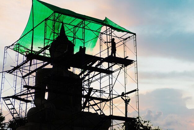 Silhouette of Repair Buddha statue at sunset