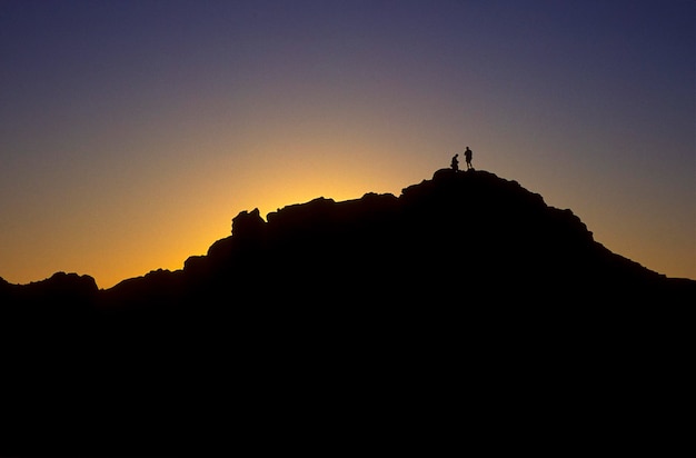 Photo silhouette rocks against clear sky during sunset