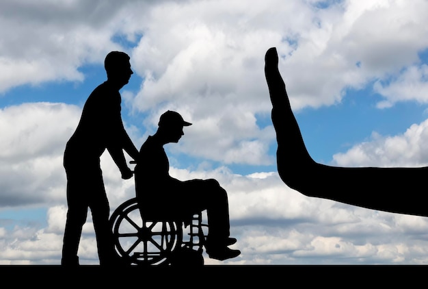 Silhouette of sad disabled man in wheelchair with nurse and hand gesture stop. The concept of care and care for people with disabilities