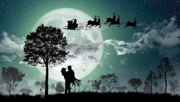 산타 클로스의 실루엣은 크리스마스 밤에 보름달 위에 순록을 타고 이동합니다.
