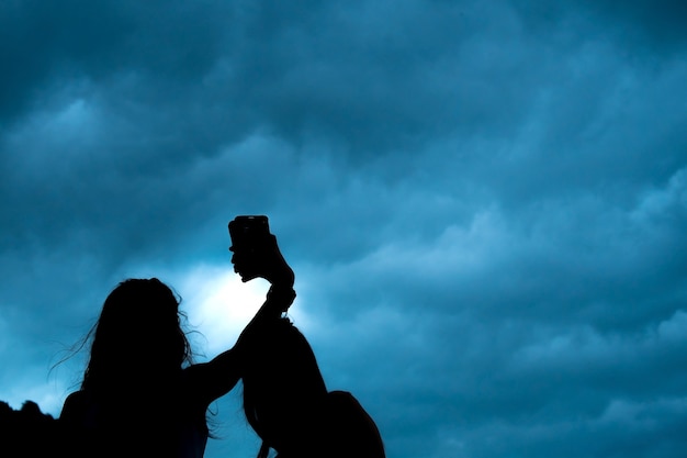 Silhouette selfie Couple of young women