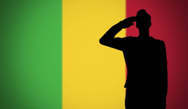 Silhouette of a soldier saluting against the mali flag
