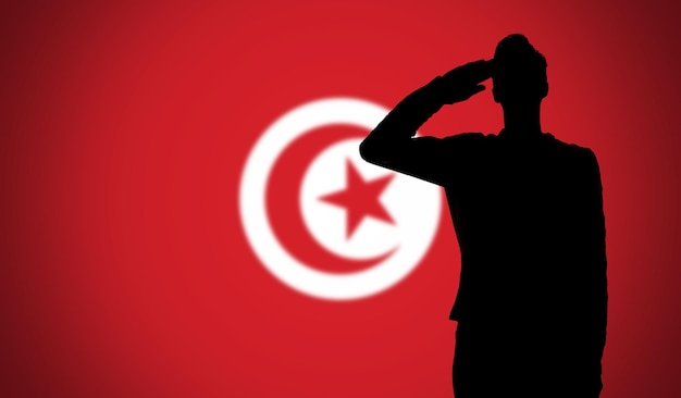 チュニジアの国旗に敬礼する兵士のシルエット