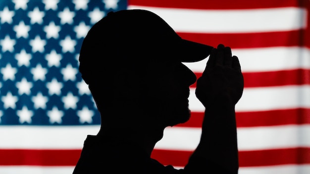 Silhouette of soldier saluting close up