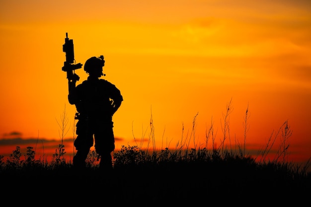 Silhouette of soldier with riflexAxA