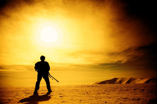 Silhouette of soldier with sniper rifle