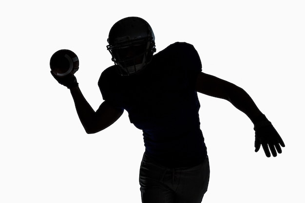 Photo silhouette sportsman throwing football