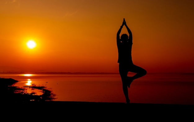 Silhouette sporty woman with sunset. Healthy and exercise activity. Lifestyle and recreation.