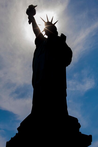 Silhouette statue of liberty against sky