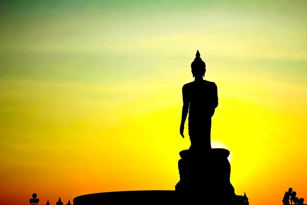 Silhouette of statue at sunset