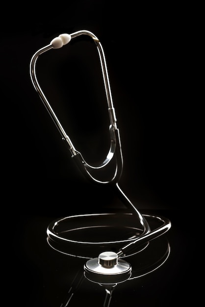 Premium Photo | Silhouette of a stethoscope on a black background.