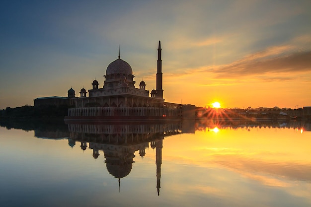 Silhouette of temple against cloudy sky at sunset