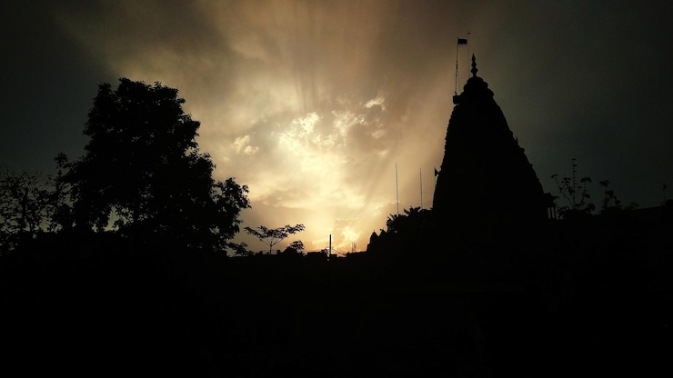 फोटो silhouette of temple against sky during sunset