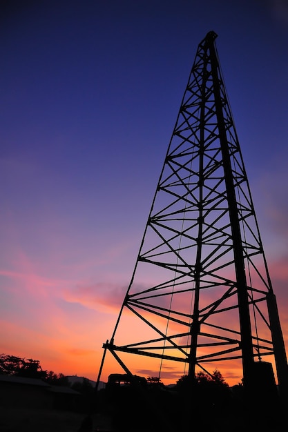 Silhouette of tower crane in twilight