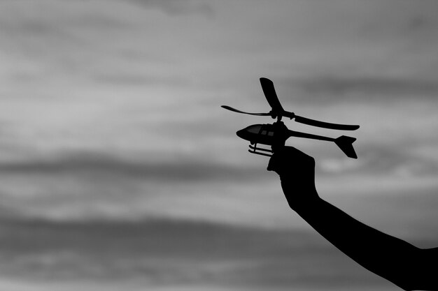 Silhouette toy helicopter in hand dream