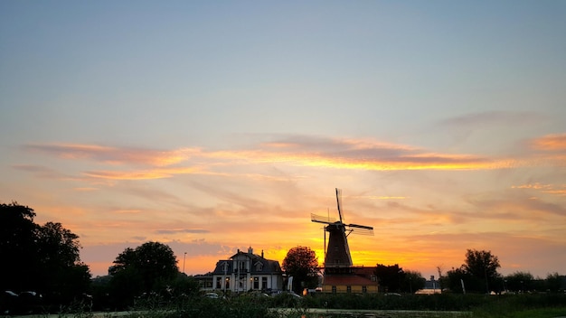 Silhouette of traditional windmill at sunset