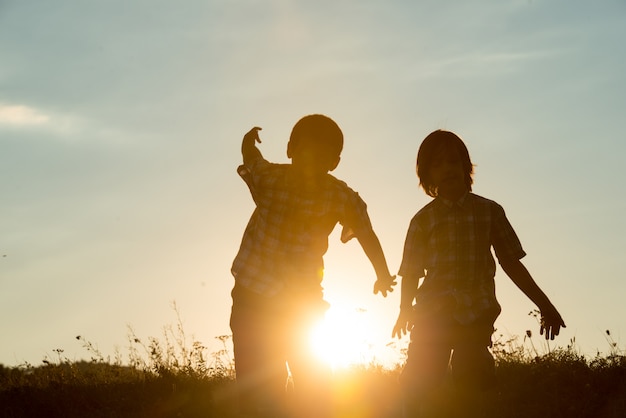 Silhouette of two brothers enjoying the freedom