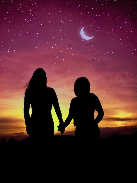 silhouette two girl holding hand
