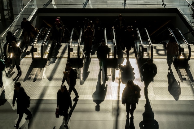 silhouette of Unrecognizable passenger and tourist walking up to the escalator to office in rush hour