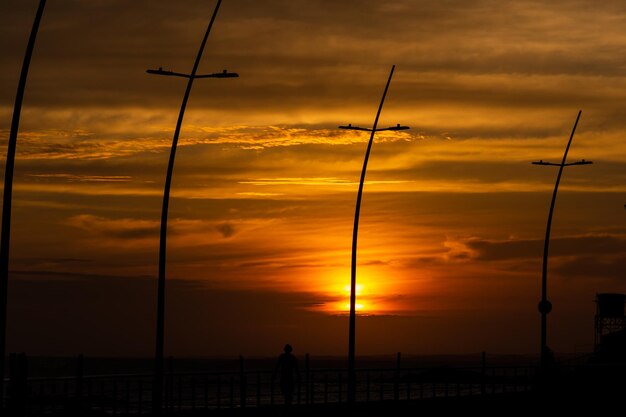 Silhouette view of power poles in silhouette in the Ondina neighborhood in the city of Salvador Bahia