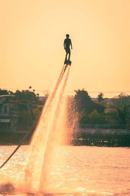 Silhouette and vintage color styl  of showing flyboard on Chaophya river during Chinese new year celebrations 