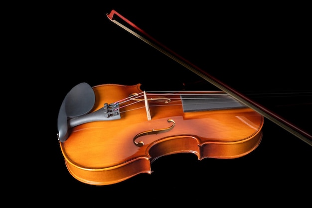 silhouette of a violin and a bow on it isolated on a black background copy space