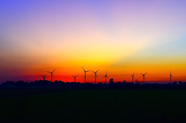 Silhouette of wind turbines at sunset