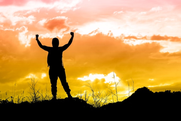 Silhouette of woman against sunset sky