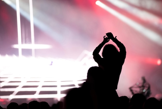 Silhouette woman in crowd during concert