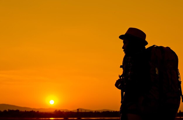 Silhouette of woman on field against sky