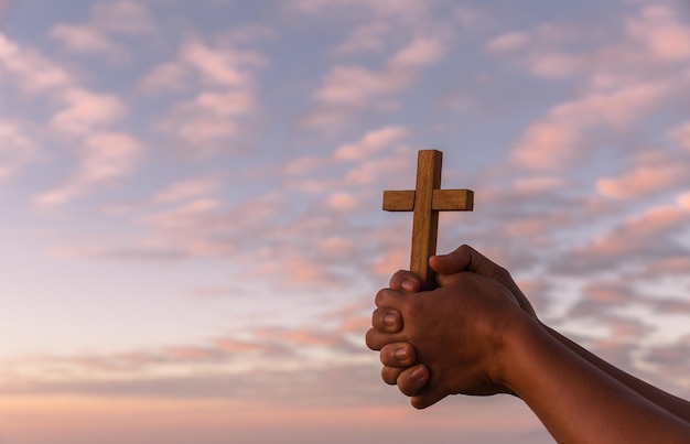 Silhouette of woman hand praying spirituality and religion\
female worship to god christianity religion concept religious\
people are humble to god christians have hope faith and faith in\
god