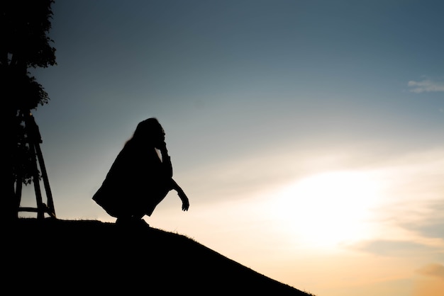 Silhouette of woman Looking for a concept at sunset