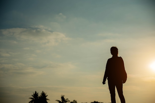 Silhouette of woman looking on sky