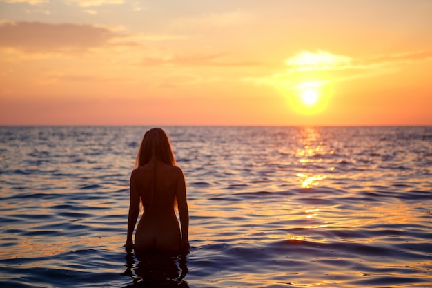 Silhouette of a woman in the sea, the concept of rest and vacation