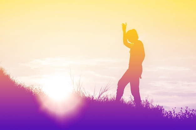 Silhouette of woman So happy at sunset