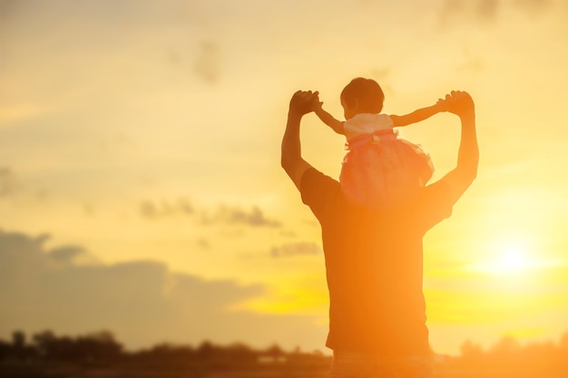 Silhouette woman standing against orange sky