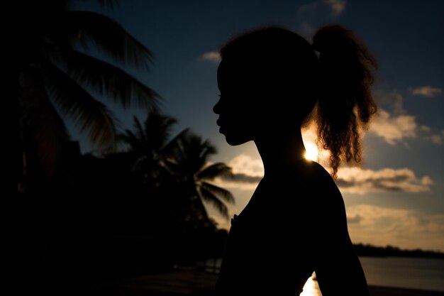 Photo a silhouette of a woman standing on a beach