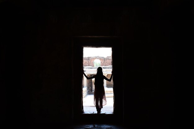 Silhouette woman standing in entrance