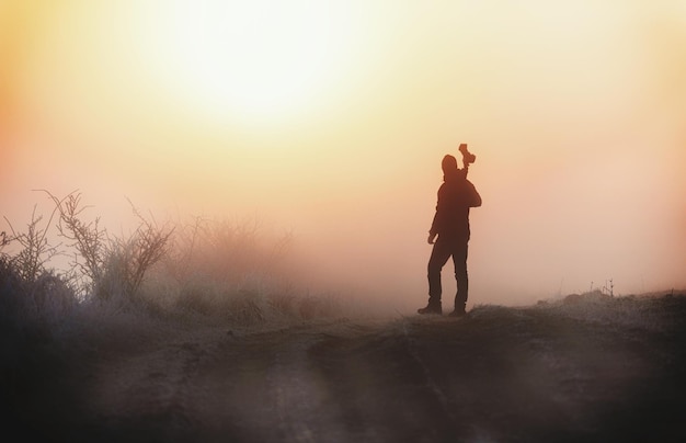 Photo silhouette of woman standing at sunset