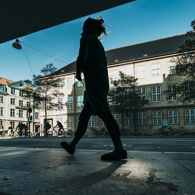 Silhouette of the woman on the street of the city