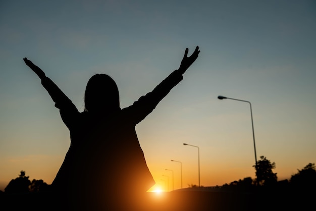 Silhouette of a woman with evening sky.