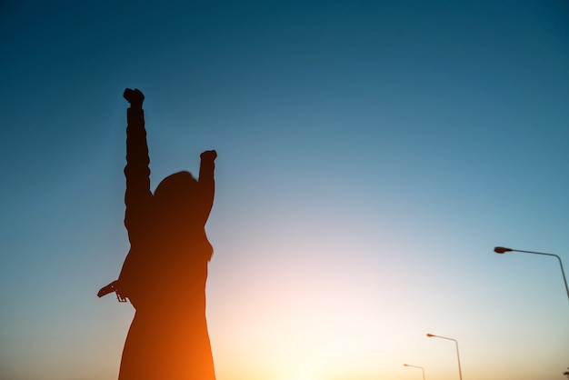 Silhouette of a woman with evening sky.