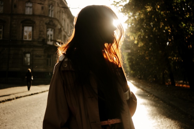 Silhouette of woman with sun behind