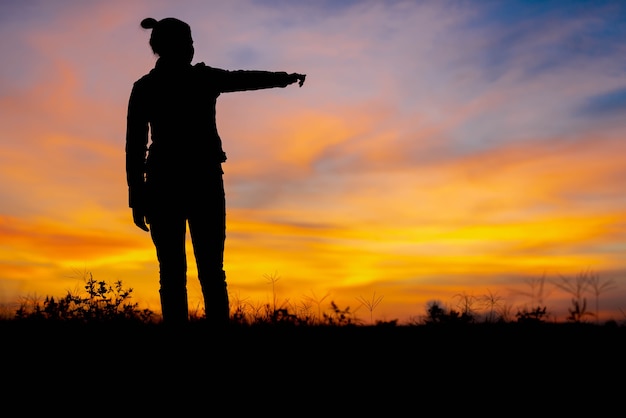 Photo silhouette women point to success at not far away.