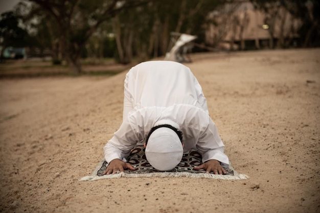 Silhouette Young asian muslim man praying on sunsetRamadan festival concept